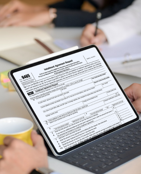 Person holding tablet viewing IRS Form 9465